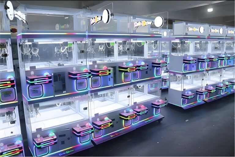 Multiple white LeYou "RainBow" claw machines with circular overhead lights, colorful LED panels (pink/blue/purple), and "PRIZE OUT" displays under bright arcade lighting.