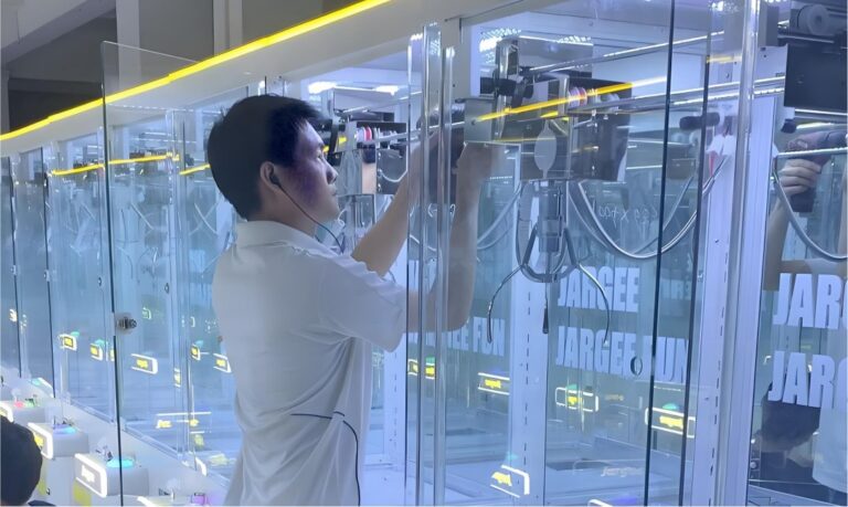 LeYou technician calibrating a claw mechanism during quality control